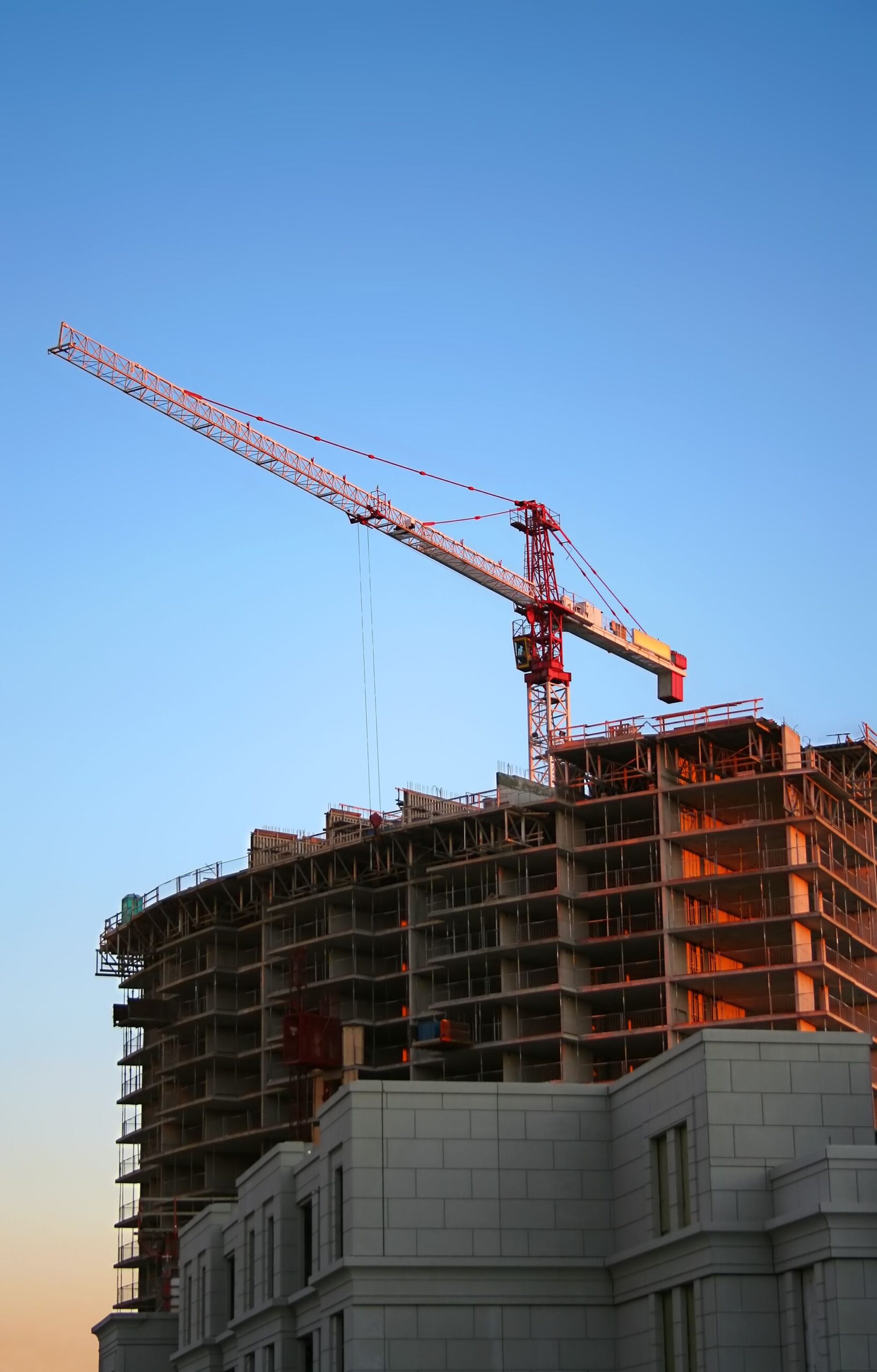 Multistory construction with tower crane — illustrative stock photo