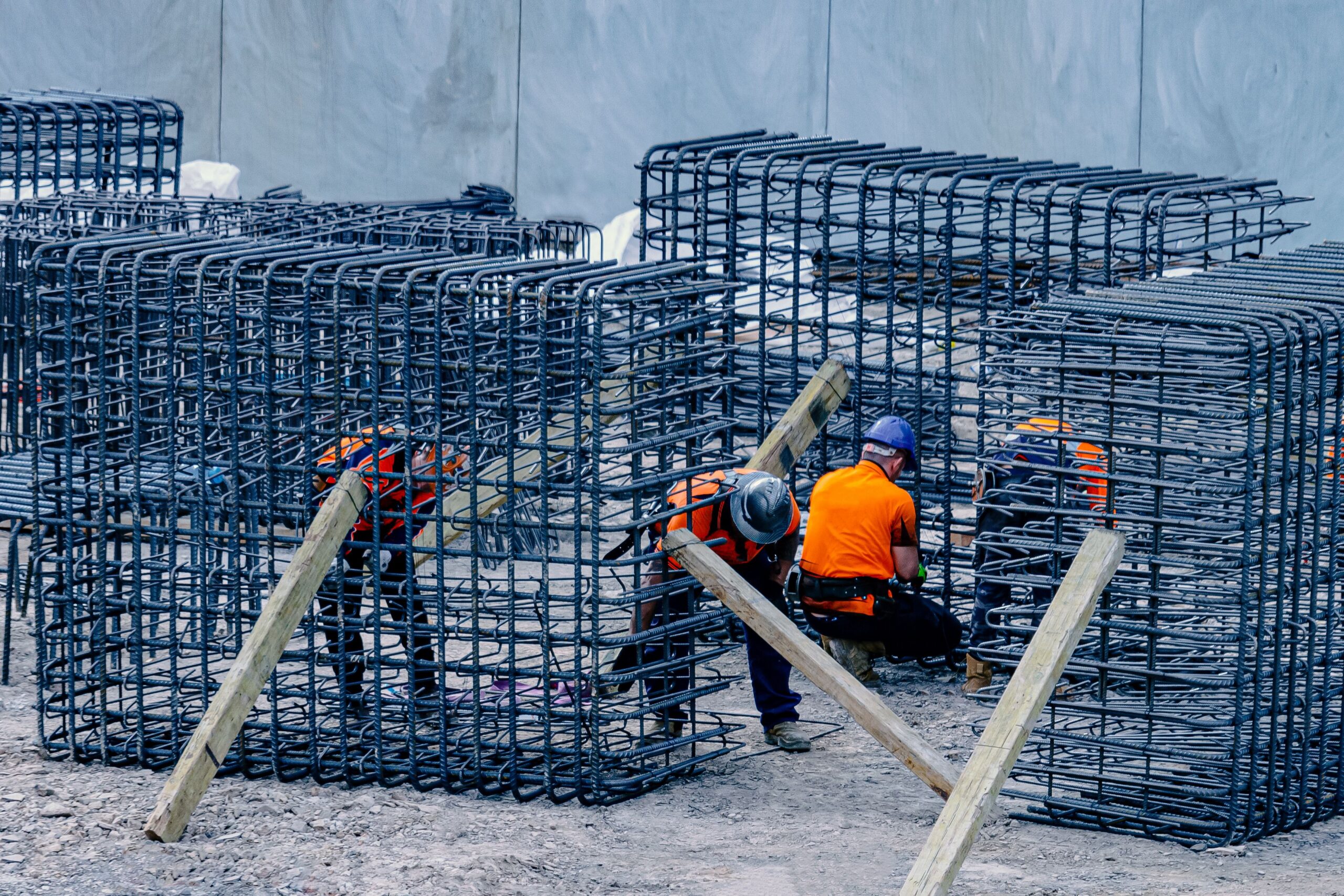 Construction team assembling reinforcement steel — illustrative stock photo