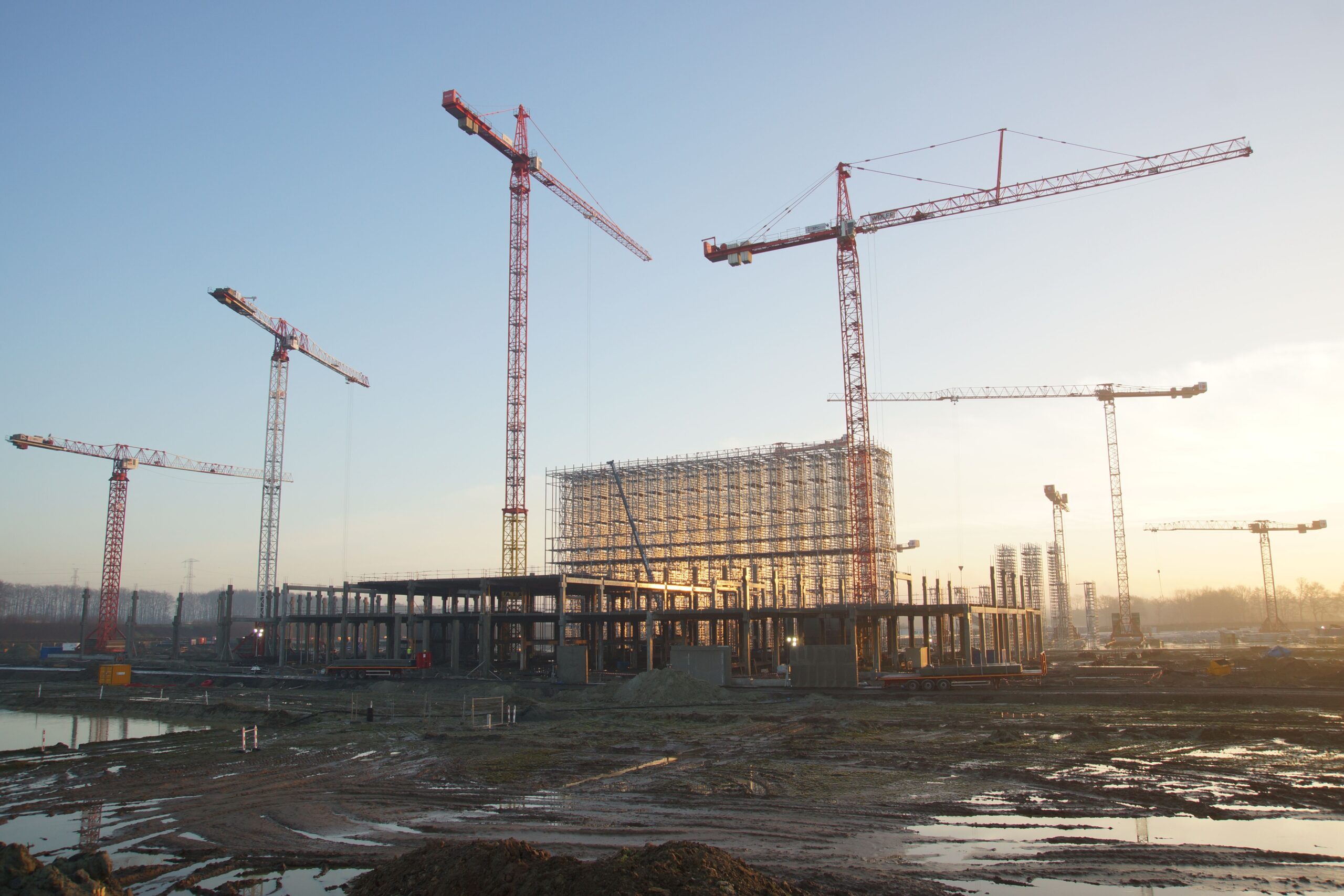 Commercial construction site with cranes — illustrative stock photo